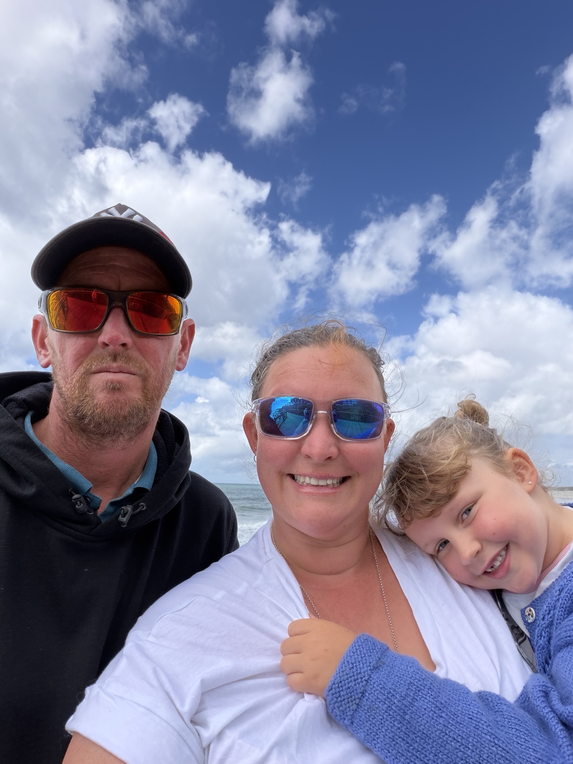 Rachel, Greg and Addy together by the sea